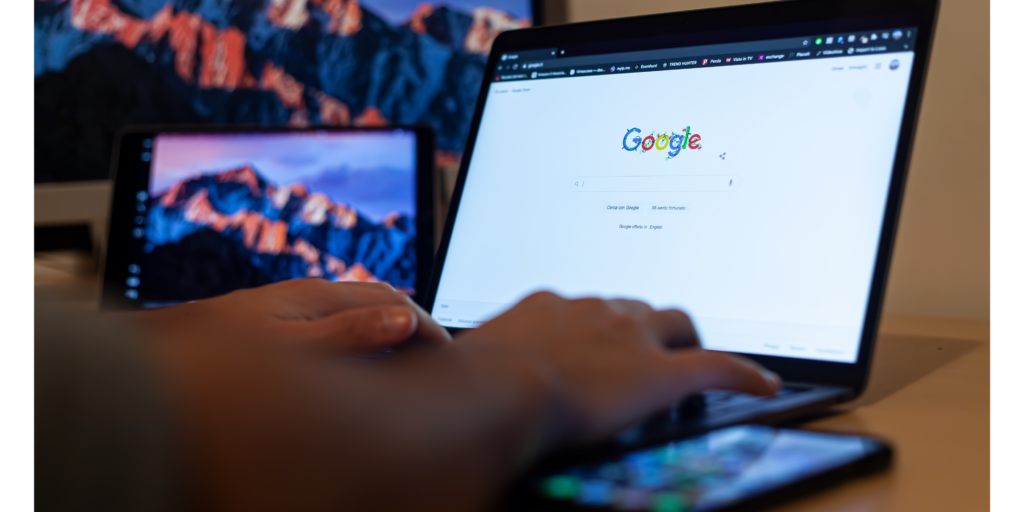 Close-Up Shot of a Person Using a Laptop on the Google Search Screen