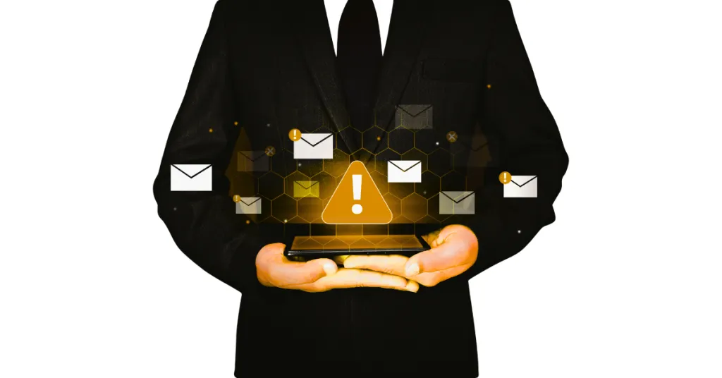 Businessman holding tablet with email alert symbols, warning of spam, phishing, or cyber attack in digital communication