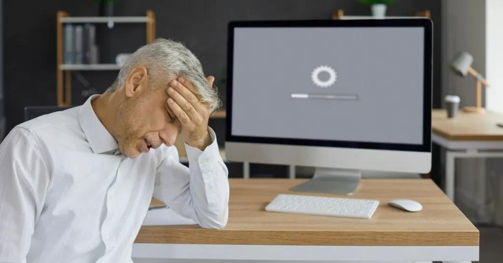 Customer Sitting in Front of Desktop Computer and Waiting for Website to Load